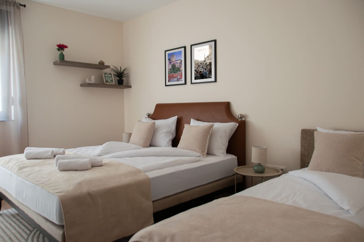 MoStay Twin Room — two elegant beds with Mediterranean bedding